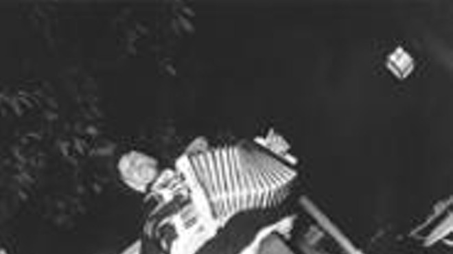 Baby Dee strikes an accordion with the crowd.