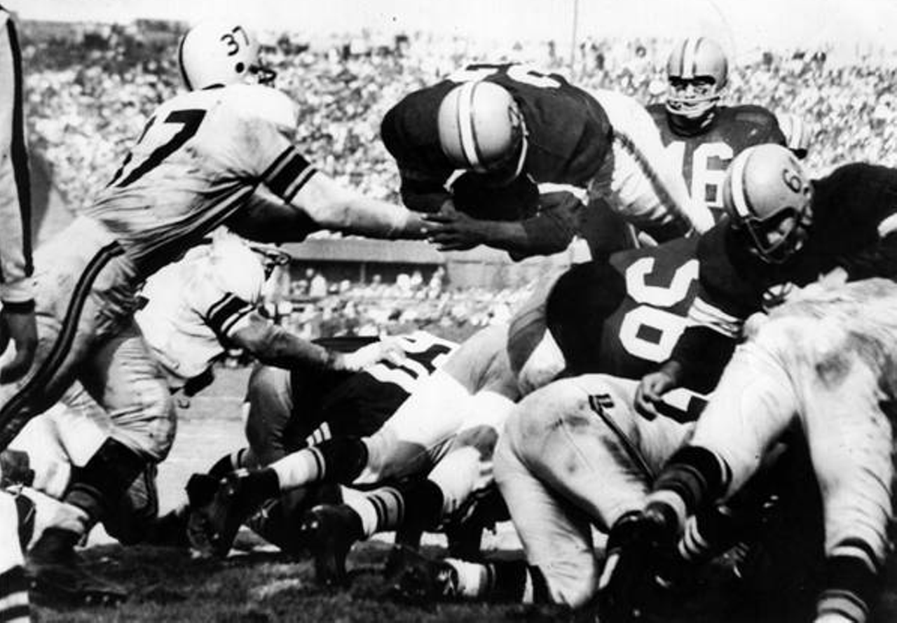 Cleveland Browns vs. Pittsburgh Steelers- 1960
Final Score- Cleveland 28: Steelers 20
Legendary Cleveland Browns' fullback Jim Brown goes up and over a mass of Pittsburgh Steeler linemen as he scores a touchdown from the 1-foot line in the 4th quarter. Also identifiable are Cleveland's Jim Ray Smith (64) and Milt Plum (16).