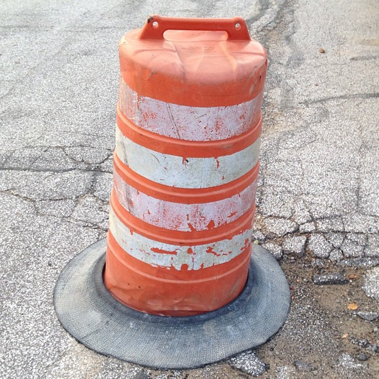Instead of filling in the pothole the city of Cleveland decided to put a construction barrel over it. #clevelandproblems