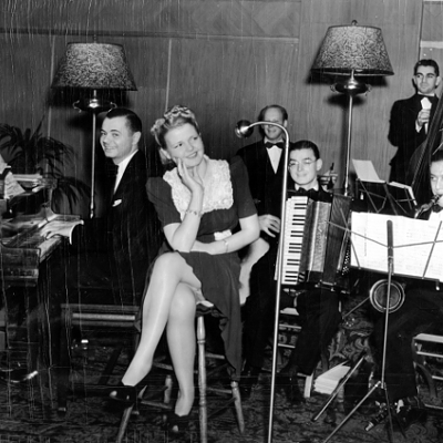 Mary Lou Siegal sings with the hotel orchestra at a holiday party in 1938.