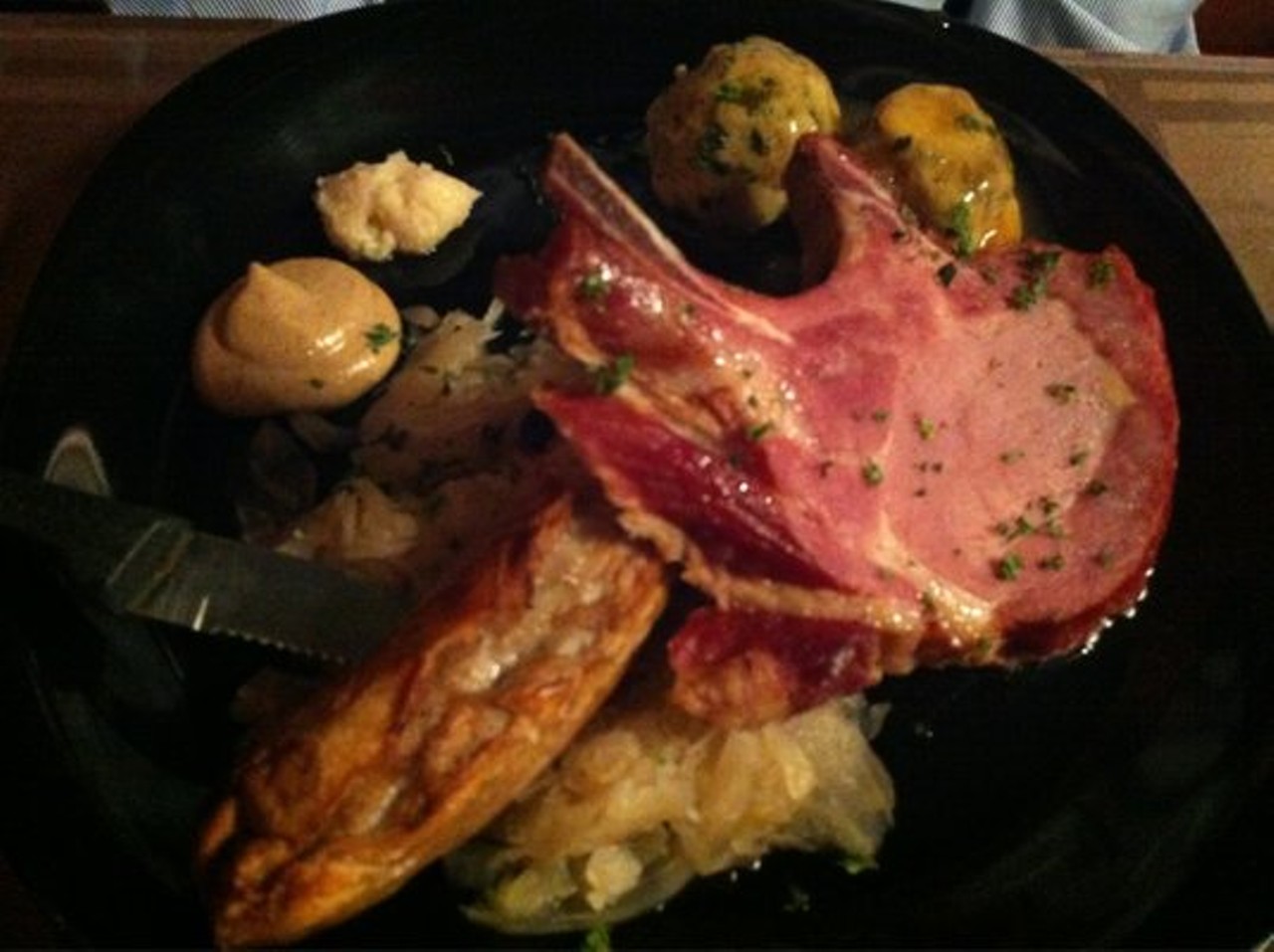 Rhienlander Platter - Grilled German style smoked pork chop and bratwurst served with potato croquettes and red cabbage