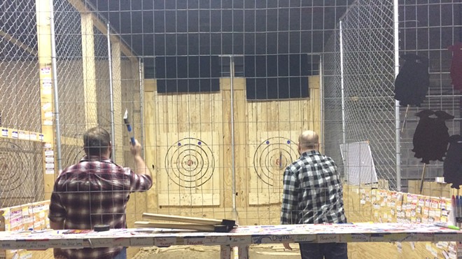 Zachary Clark and Steve Bauer practice before Cleveland Axe Throwing League begins.