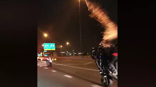 Here's a Guy Popping a Wheelie While Shooting Off Fireworks on the Innerbelt Bridge