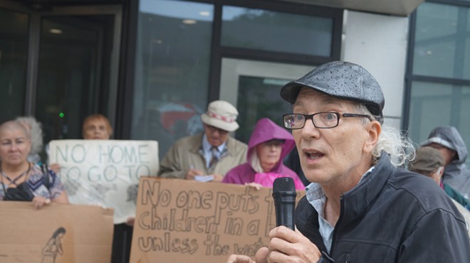 Organizer Don Bryany leads a small group in a chant supporting refugees, (6/20/19).