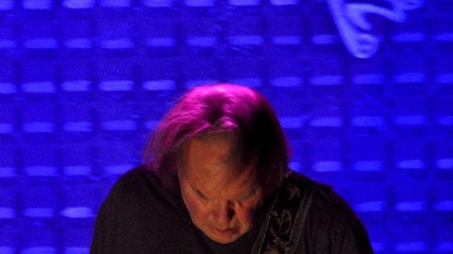 Neil Young, performing at Wolstein Center.
