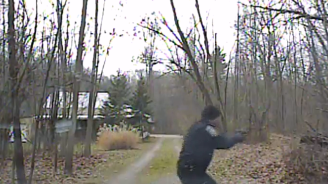 Police officer Ryan Doran draws his gun after exiting his patrol car. Al Merini is never seen in the video.