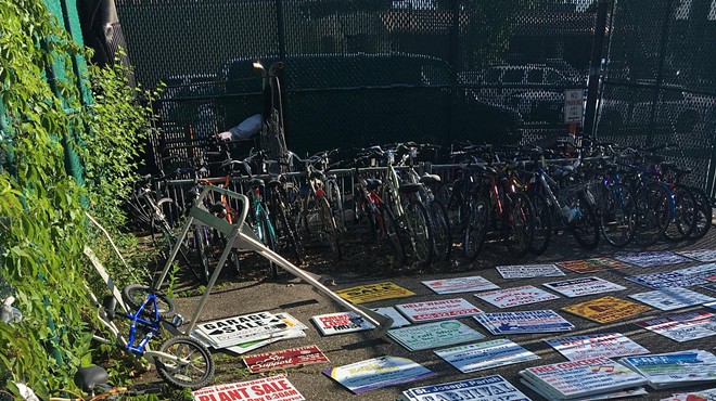 Stolen yard signs from Avon Lake yards found stacked and neatly arranged.