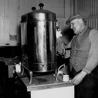 Vendor getting ready to sell coffee and hot dogs, 1927.