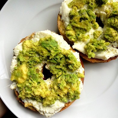 Loaded bagel with mustard, ricotta, and avocado, seasoned with a little salt and white pepper at CLE Bagel Co.