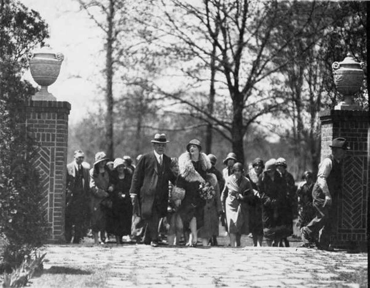 City Manager Hopkins and Ethel Barrymore entering gate at Shakespeare Gardens. c. 1926