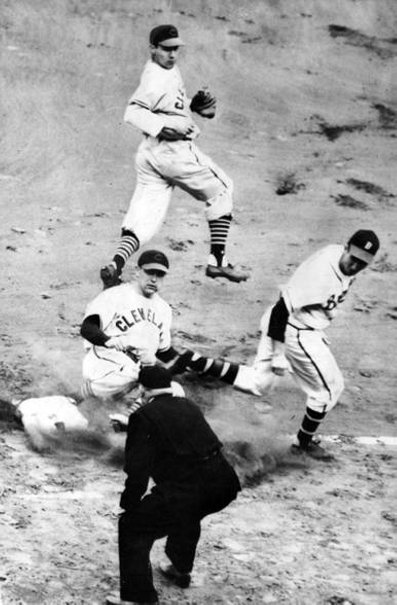 Boston Braves' Alvin Dark is out at first in World Series game one, Indians' Eddie Robinson makes the play with Bob Feller covering, 1948