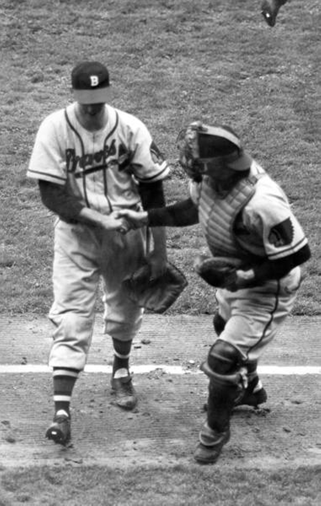 Boston Braves pitcher Warren Spahn receives congratulations from Bill Salkeld in Game 5 of the World Series against the Cleveland Indians in 1948