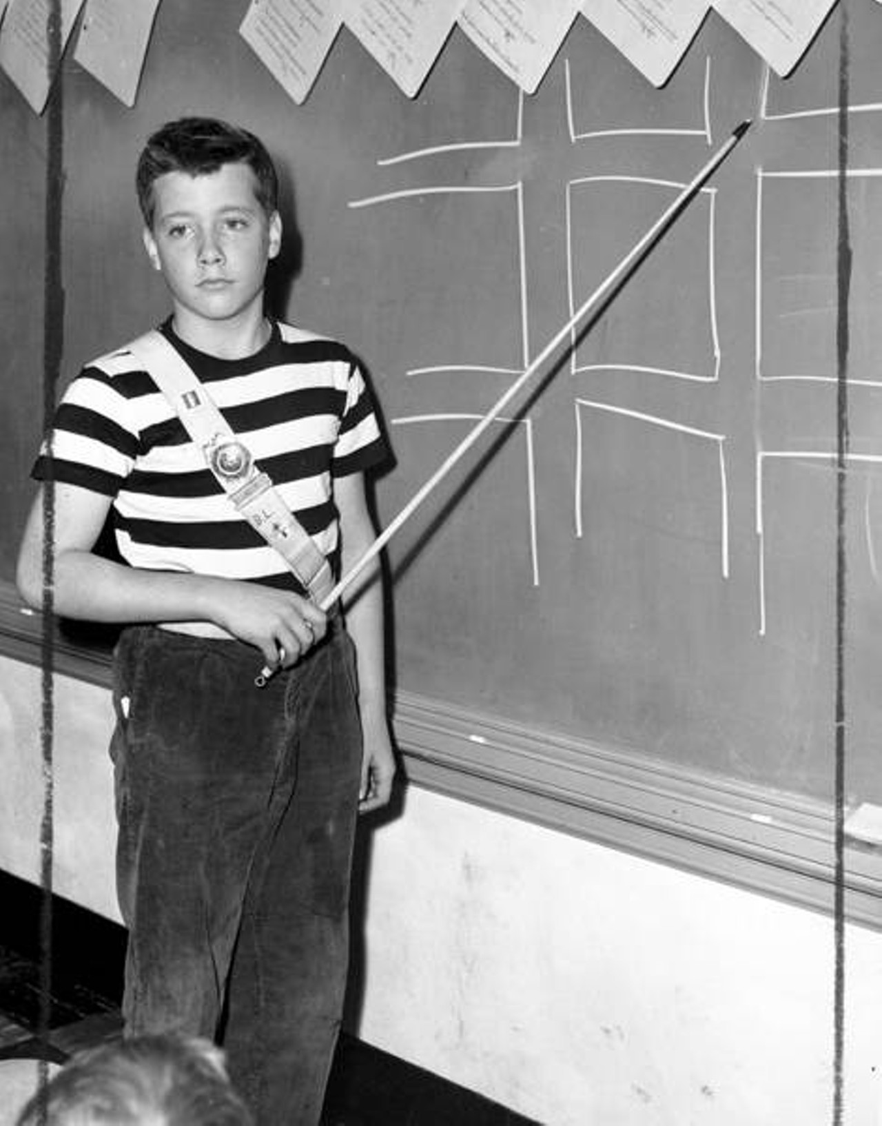 Bill Louy stands at a chalkboard at the Church of St. Dominic School in Shaker Heights., 1942
