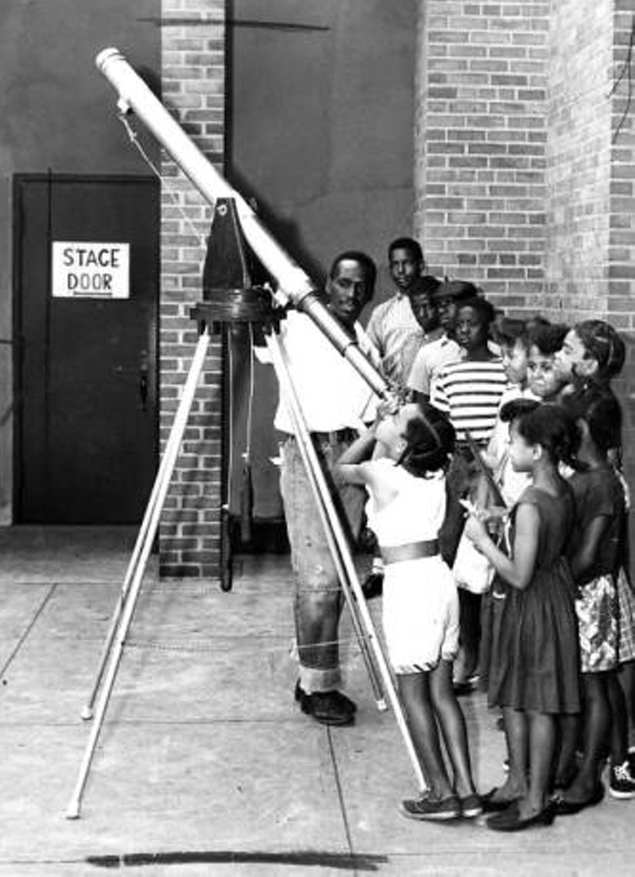 Children look through a telescope at Karamu House, 1961