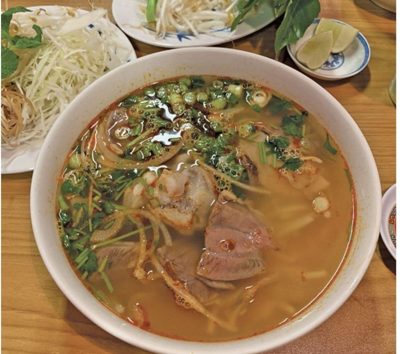 Pho Lee
3710 Payne Ave. #10, Cleveland 
There can never be too many pho spots. It's always pho season, but colder weather screams for bun bo hue, a meatier, spicier and, we&#146;d argue, more winter-appropriate brew. The version served here starts with deeply flavorful beef stock and is kicked up in all sorts of ways, evident by the burnt amber hue and pools of red chili oil that slick the surface. Unlike with pho, there's only one version, a hat-size bowl with thin-sliced beef, pork roll, tendon, an unwieldy knuckle of some sort and thick, round noodles. It's paired with an exceptionally fresh garnish plate overflowing with snow-white bean sprouts, shredded cabbage, fried banana blossoms, fresh mint and limes.
Photo via Scene Archives