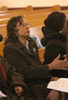 Antoinette Foster (left) sits next to Rosetta Smith at their brother's funeral.