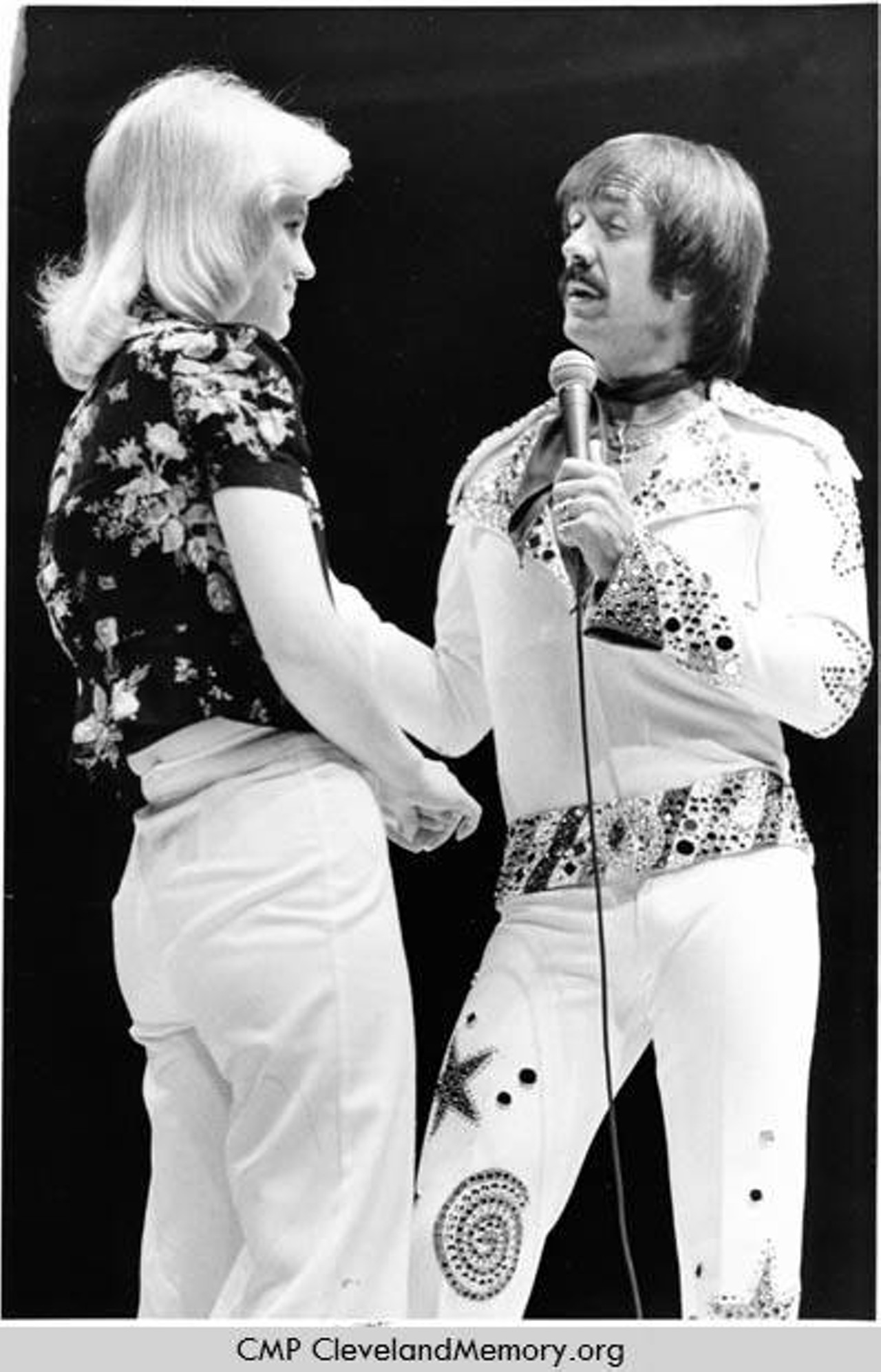 Women pulled on stage during a Sonny Bono show, 1977