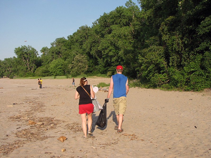 Volunteers cleaning litter on the beach.