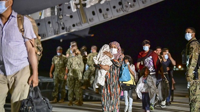 Afghan evacuees disembark a U.S. Air Force C-17 Globemaster III at Naval Air Station Sigonella, Aug. 22, 2021.