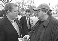 Michael Moore (right) talks with Congressman John - Tanner (D-TN) on Capitol Hill.