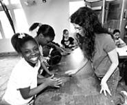 Osterland's classroom assistant Santina Protopapa - (right) helps Doniesha Kinney, Samantha Childs, and - Destiny Sutphin (from left) transform clay into art. - WALTER  NOVAK