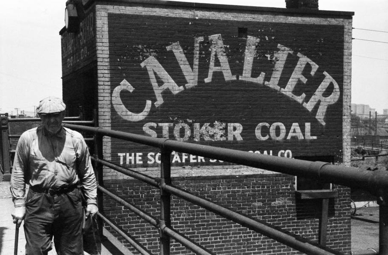 Man Walking by "Cavalier Stoker Coal" Sign