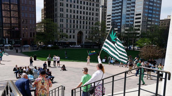 COLUMBUS, Ohio — APRIL 20: Pricilla Harris, executive director of Sensible Movement Coalition and lobbying dir. NORML Appalachia (center) holds a flag in front of supporters of legalized marijuana, April 20, 2023, outside the Statehouse in Columbus, Ohio.