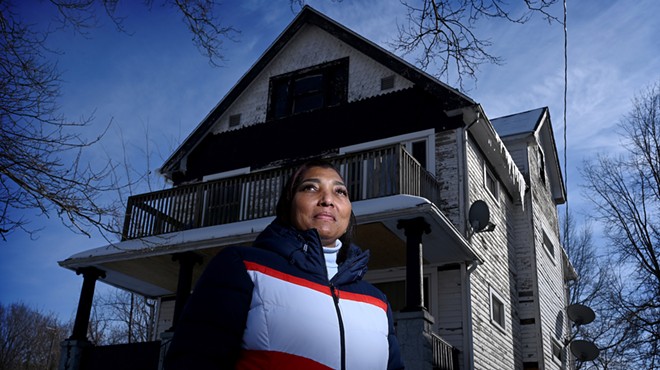 Tuesday Gibson outside her Buckeye-Woodhill home. Gibson didn’t complete Cleveland’s Exterior Paint Program, and she’s not alone. About 64 percent of applicants who were approved in 2020 and 2021 have not finished painting their homes.