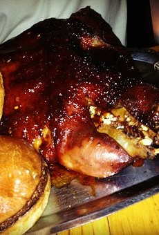 This is an entire roasted pig's head staring back at you. Complete with BBQ sauce and a raw vegetable salad. Don't knock it till you try it, the various components are quite tasty!