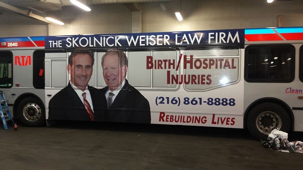 Howard E. Skolnick (L) as seen on the side of a RTA bus - Courtesy of My Local Services