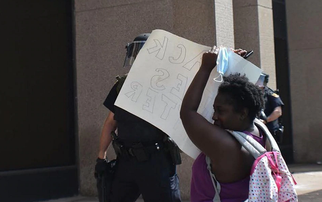 PHOTO INCLUDED IN FEDERAL LAWSUIT OF JALEESA BENNETT TRYING TO USE A SIGN TO PROTECT HERSELF FROM PEPPER SPRAY