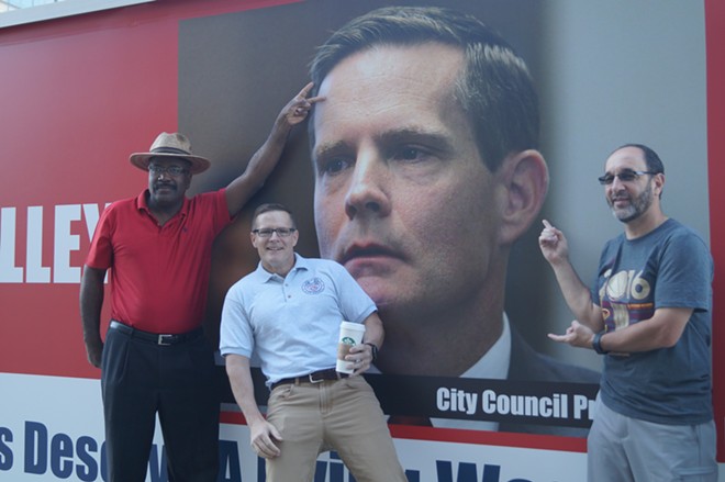 Councilmen Kevin Conwell, Kevin Kelley and Tony Brancatelli mugging in front of an anti-Kelley truck outside City Hall in 2016. - SAM ALLARD / SCENE