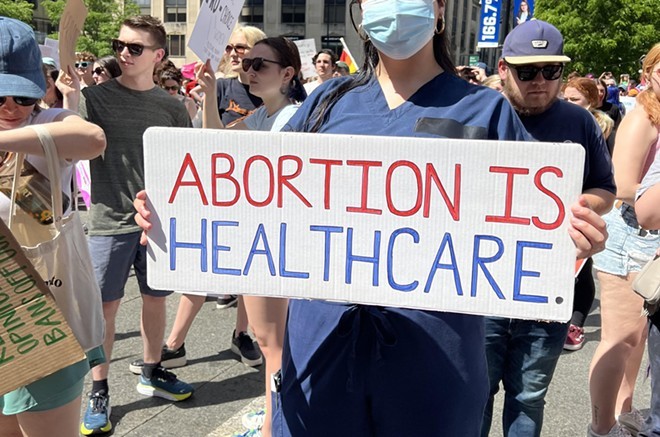 A nurse holds a sign in support of abortion access at a Planned Parenthood rally in Downtown Cincinnati on May 15, 2022. - Madeline Fening