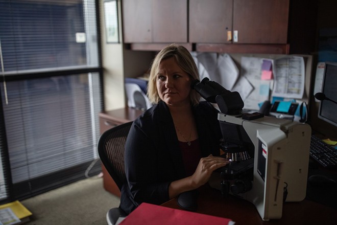 Dr. Shelley Odronic works in her office in Lima, Ohio. Odronic, a pathologist, noticed severe damage in the placentas of pregnant people who had COVID-19. - Credit: Maddie McGarvey for ProPublica