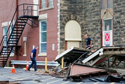 Workers begin cleaning up debris surrounding the New Life Calvary Church off East 79th and Euclid Ave., on Friday afternoon. - Mark Oprea