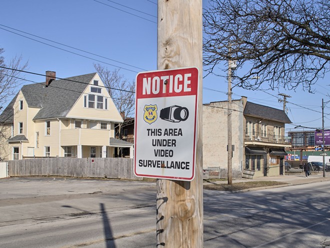 A sign marks the presence of Cleveland police surveillance cameras at the intersection of Detroit Avenue and West 89th Street in Cleveland. - Ross Mantle for The Marshall Project