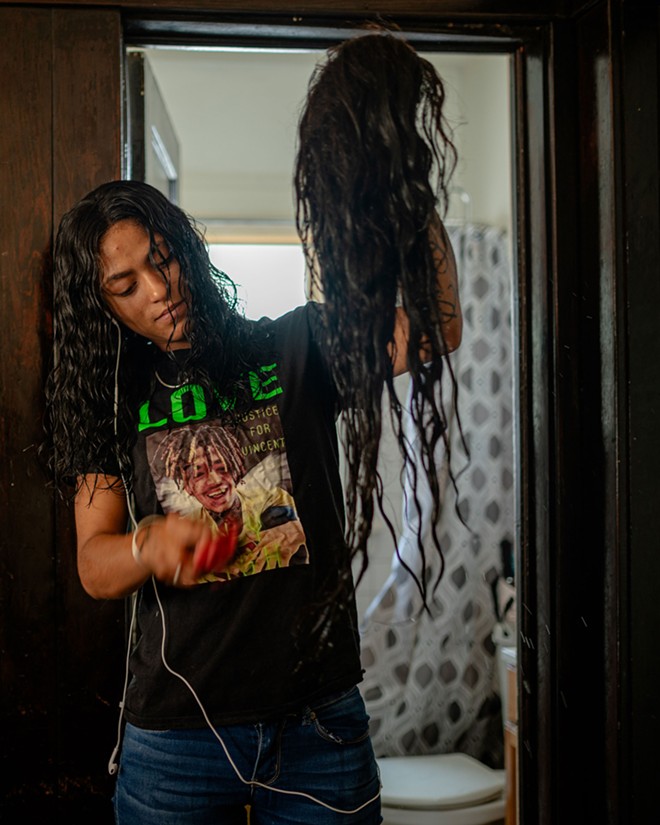 Diamond brushes out a wig for her mother on July 9, 2022 as they get ready to protest against the killing of Jayland Walker, a young Black man fatally shot by police in Akron, Ohio - Michael Indriolo for The Marshall Project