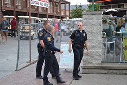 Seasonal police officers walking PIB's main drag. - Doug Brown / Scene