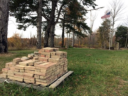 Bricks are stacked at one end of the Medina County Home Cemetery.