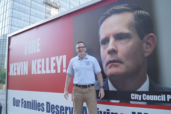 Council President Kevin Kelley volunteers for a photo in front of the SEIU Local Mobile Billboard. - SAM ALLARD / SCENE