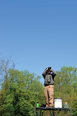 Tom Bartlett scans the skies for birds May 13 during the Biggest Week in American Birding. - PHOTO BY ERIC SANDY