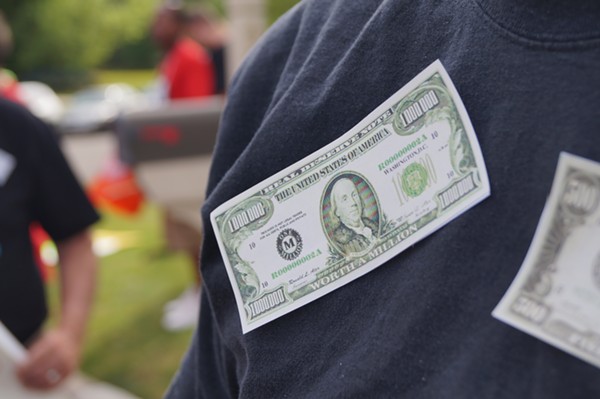 Protesters taped fake money to their clothes; Frank's Fat Cat Festival Protest (6/28/17) - SAM ALLARD / SCENE