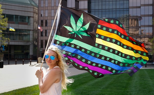 APRIL 20: Samantha Farrell with Sensible Movement Coalition holds a flag depicting a cannabis leaf at a rally in support of legalized marijuana, April 20, 2023, outside the Statehouse in Columbus, Ohio.