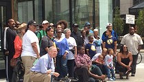 Group of Mostly Black Detroit Residents Takes Photo at Site of Dan Gilbert's Controversial Ad