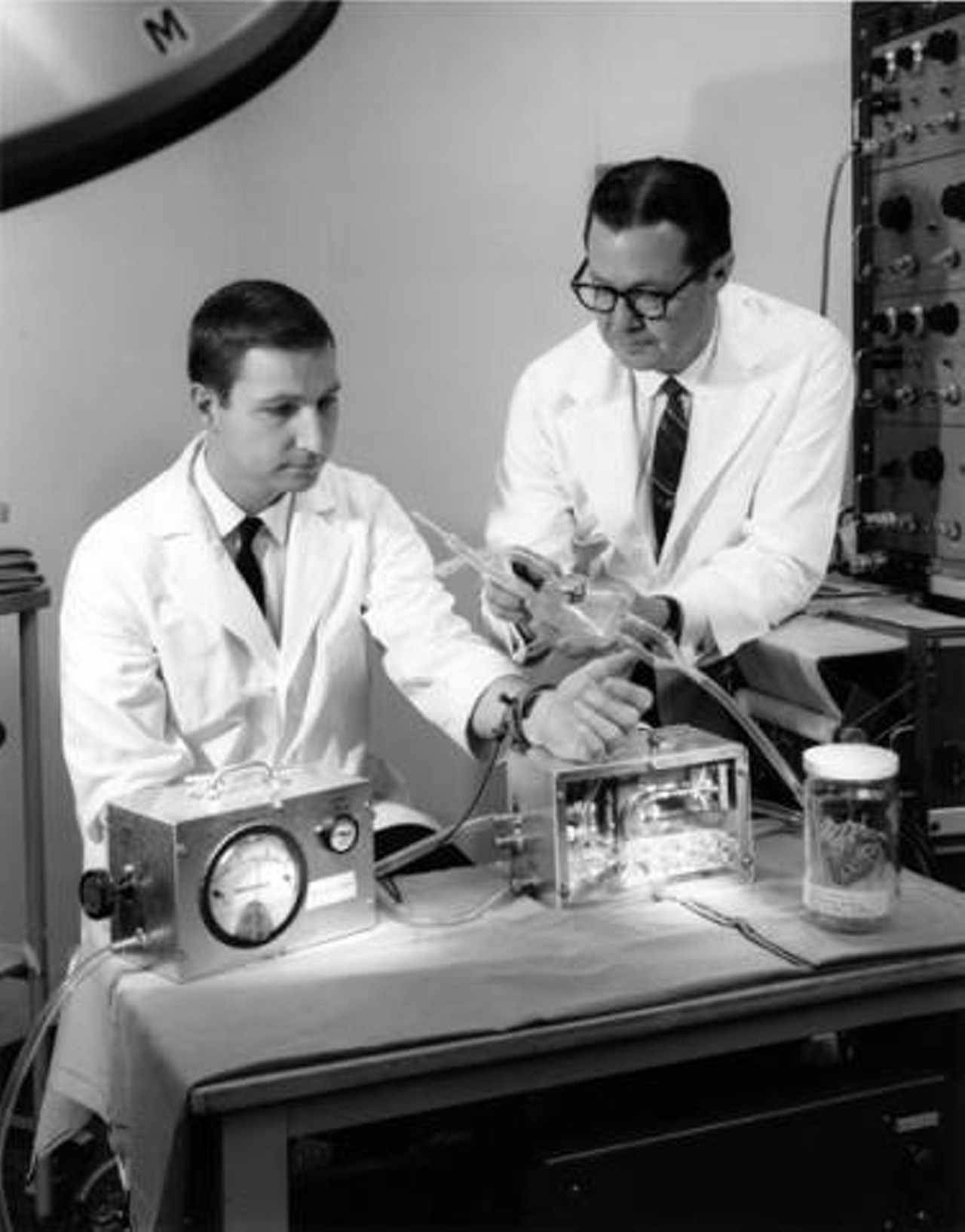 Dr. Earle B. Kay and a researcher at Lewis Research Center test a heart assist pump designed for St. Vincent Charity Hospital. 1967