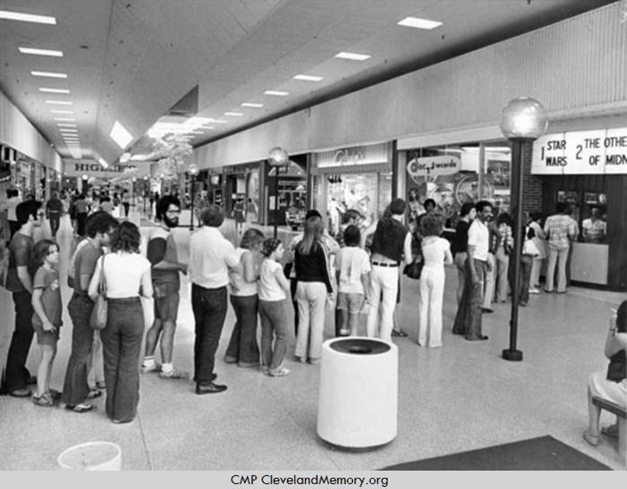 ''Sev. Ctr. Theatre line up.'' — photo verso. A line of movie goers wait to buy tickets to Star Wars at Severance Shopping Center. 1977