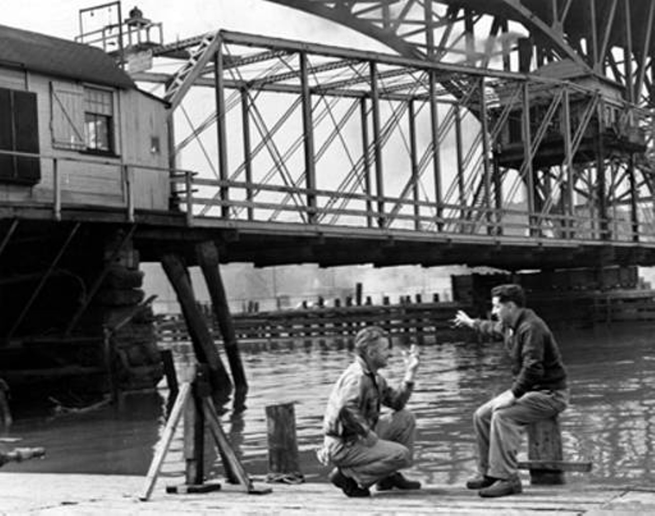 Men taking a break on the side of Cuyahoga River, 1945.